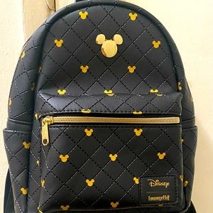 Loungefly with gold Mickey head print all over